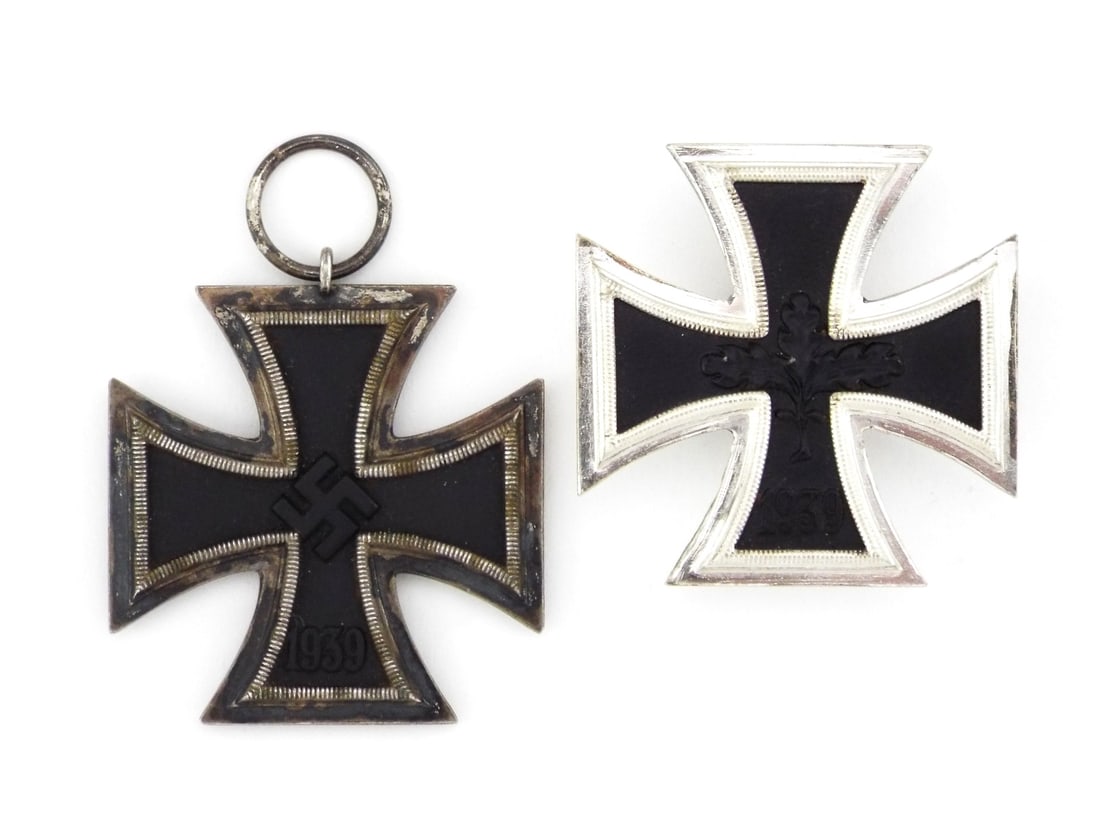 German WWII IRON CROSS 1ST & 2ND CLASS: Second Class cross displays heavy patina and silver loss to the outer ribbing. First Class post war veteran's variant features an oak leaf center with a bright, frosted finish and functional vertical