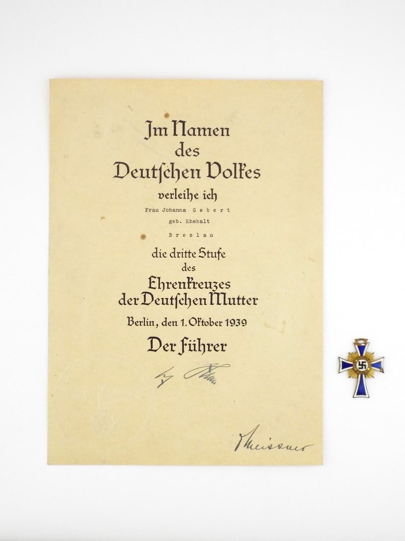 German WWII MOTHER'S CROSS BRONZE with Certificate: Cross features crisp cobalt and white enamel with light surface age and minor edge chipping. Reverse shows factory Institution Date 16. Dezember 1938 with intact suspension loop. Matching award docume
