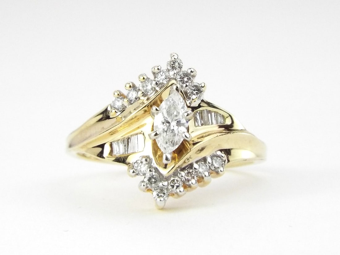 14K Yellow Gold Marquise-Cut Natural Diamond with Diamond Baguette Accents and Chevron Style: 14K Yellow Gold Marquise-Cut Natural Diamond with Diamond Baguette Accents and Chevron Style Shoulders, Diamonds .4 tcw, Center Stone .25ct, Weight 3.5g, Size 7.