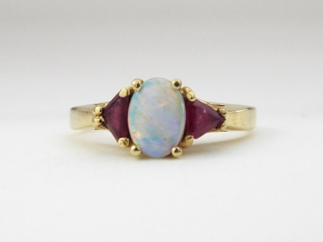 14K Yellow Gold Opal Ruby Ring: 14K Yellow Gold Opal Ruby Ring, Weight 2.7g. Direct credit card payment will not be accepted for this Lot. Accepted payment methods include cash, certified bank check, wire transfer, and ACH.