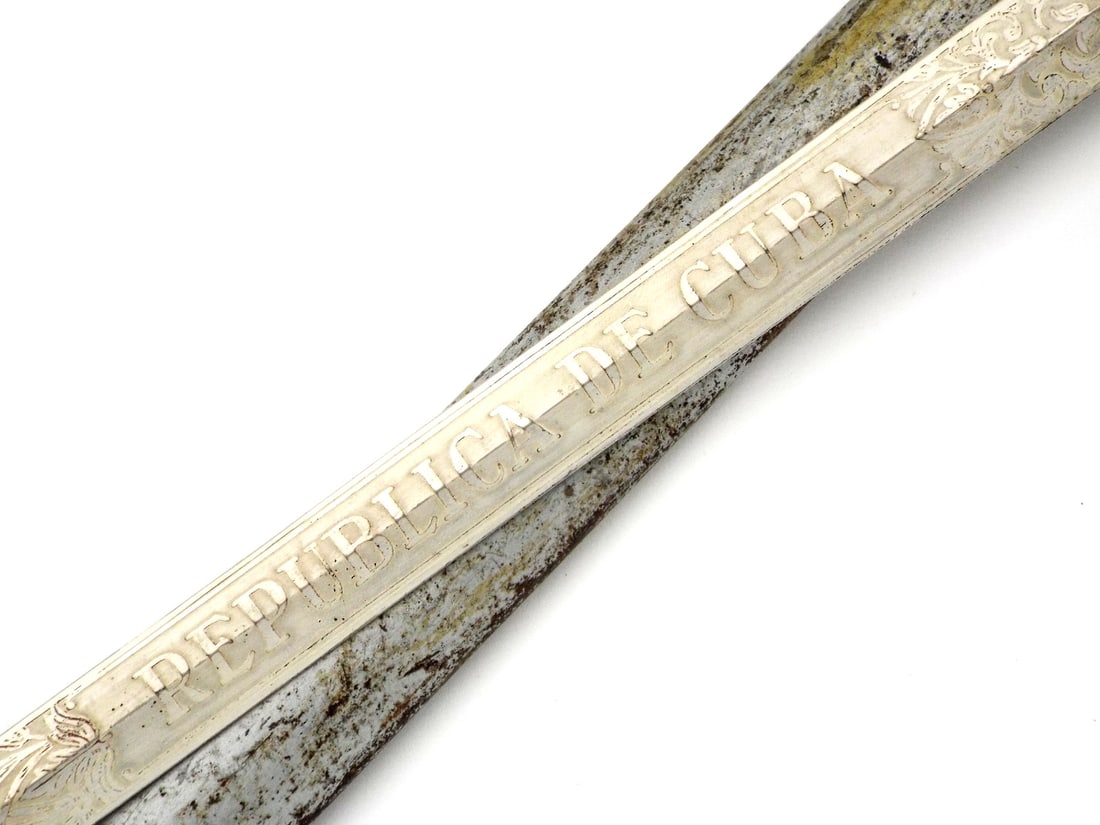 CUBAN Republic ARMY OFFICER SWORD with Scabbard: Double edged blade displays deep engraving with REPUBLICA DE CUBA and EJERCITO - Army alongside floral motifs, showing scattered spotting and graying. The gilded brass D-guard features the Cuban natio
