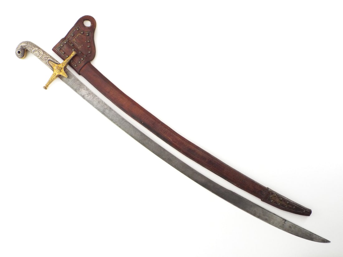 Beautiful SILVER HILTED Officers SWORD Leather Scabbard: 19th century with a curved single edged blade featuring false edge and detailed foliage engraving on both faces, engraved with British coat of arms and "Victoria" inscription for queen Victoria, showi