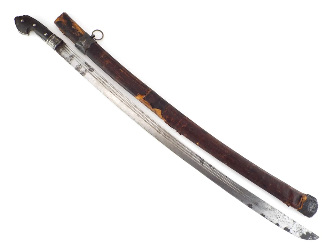 Polish 18th C. KARABELA BATTLE SWORD with Silver Overlay Work: Single edged steel blade shows multiple fullers with significant surface oxidation toward the tip. Handle features a dark wood grip secured by three domed rivets, terminating in a split pommel with en