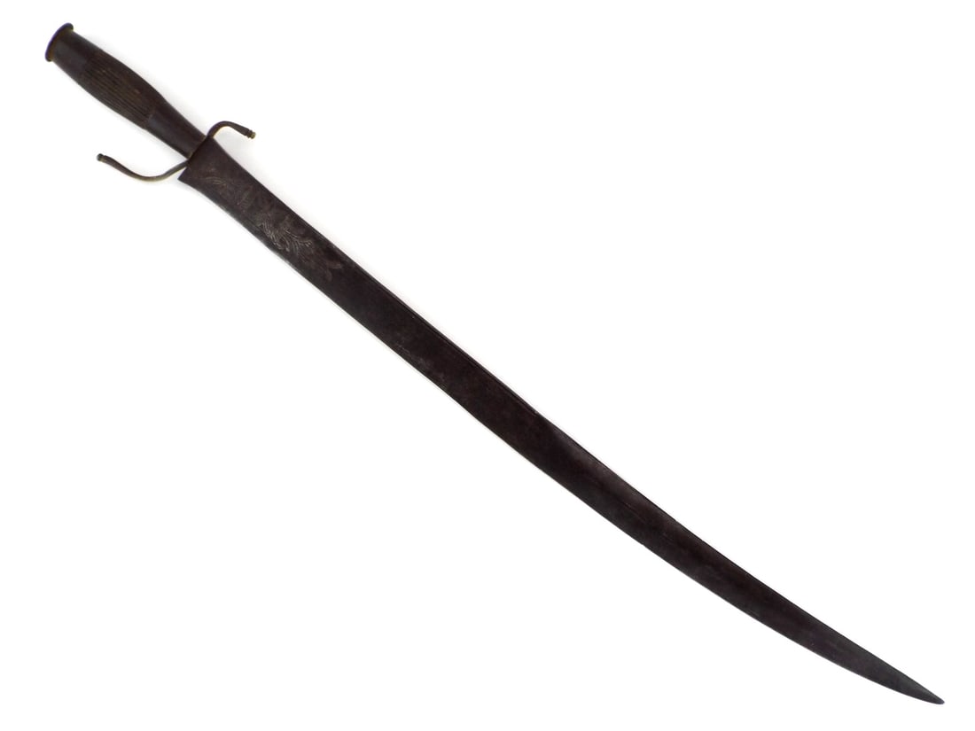 19th C. Spanish PHILIPPINE SWORD Coin Pommel Cap: Curved single edged blade exhibits mellowed patina with primitive floral and geometric engravings. The hilt is constructed with a fluted hardwood grip, displaying elegant hand wear and a solid feel wi