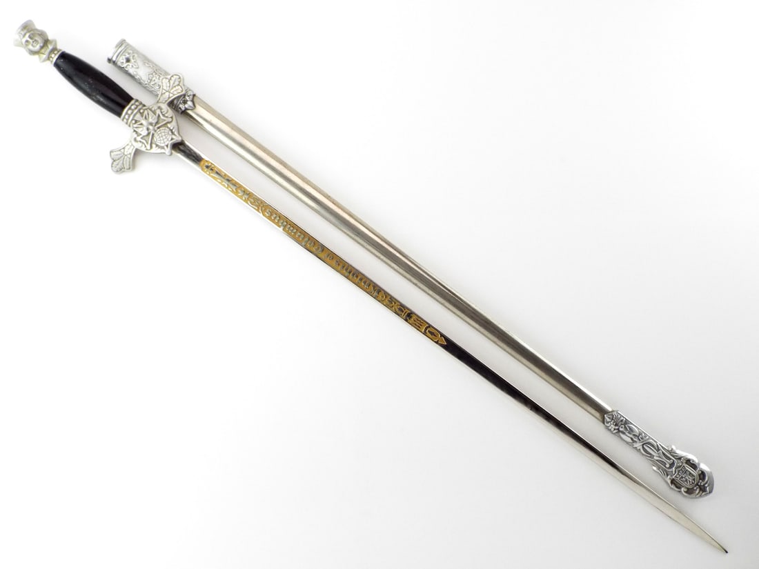 US Mid Century KNIGHTS OF COLUMBUS SWORD Gold Wash Engraving: Displays gilded Knights of Columbus inscription within decorative frost engraving on the blade, showing minor oxidation at the ricasso. Cast white metal guard features the Fourth Degree emblem with li