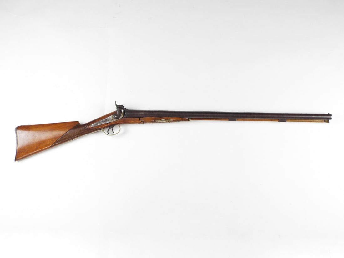 Belgian Mid-19th C. DOUBLE BARREL PERCUSSION SHOTGUN: Side by side damascus steel barrels show plum patina and localized flash pitting at the breech. The walnut stock features a checkered wrist but suffers a significant structural fracture at the
