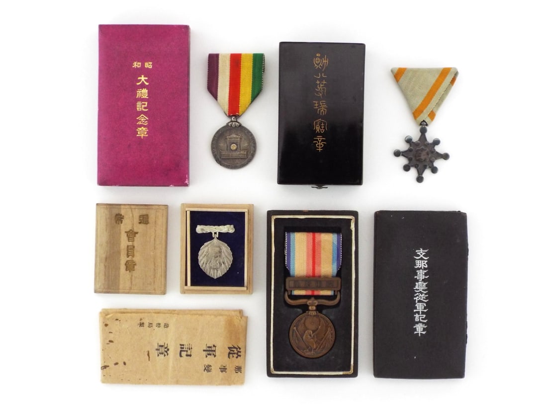Group of 4 Cased Japanese MILITARY & CIVIL DECORATIONS: Group of four medals comprising a silver 1928 Enthronement Commemorative with slight ribbon fraying, an 8th Class Order of the Sacred Treasure showing dark silver patina, a bronze China Incident War M