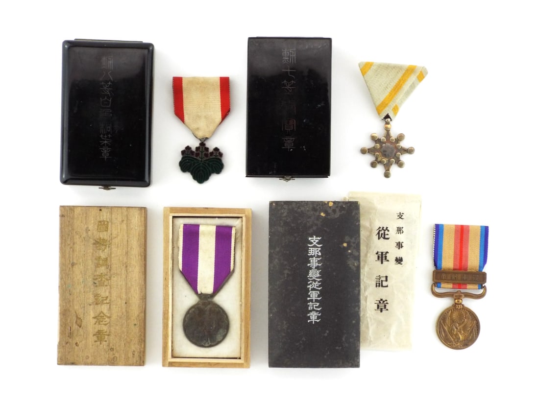 Group of 4 Japanese Imperial MILITARY MERIT MEDALS In Silver & Bronze: Aged group comprising China Incident War Medal showing moderate patina, 8th Class Order of the Rising Sun with intact silver paulownia leaves, 1920 Census Commemorative Medal with light surface wear, 