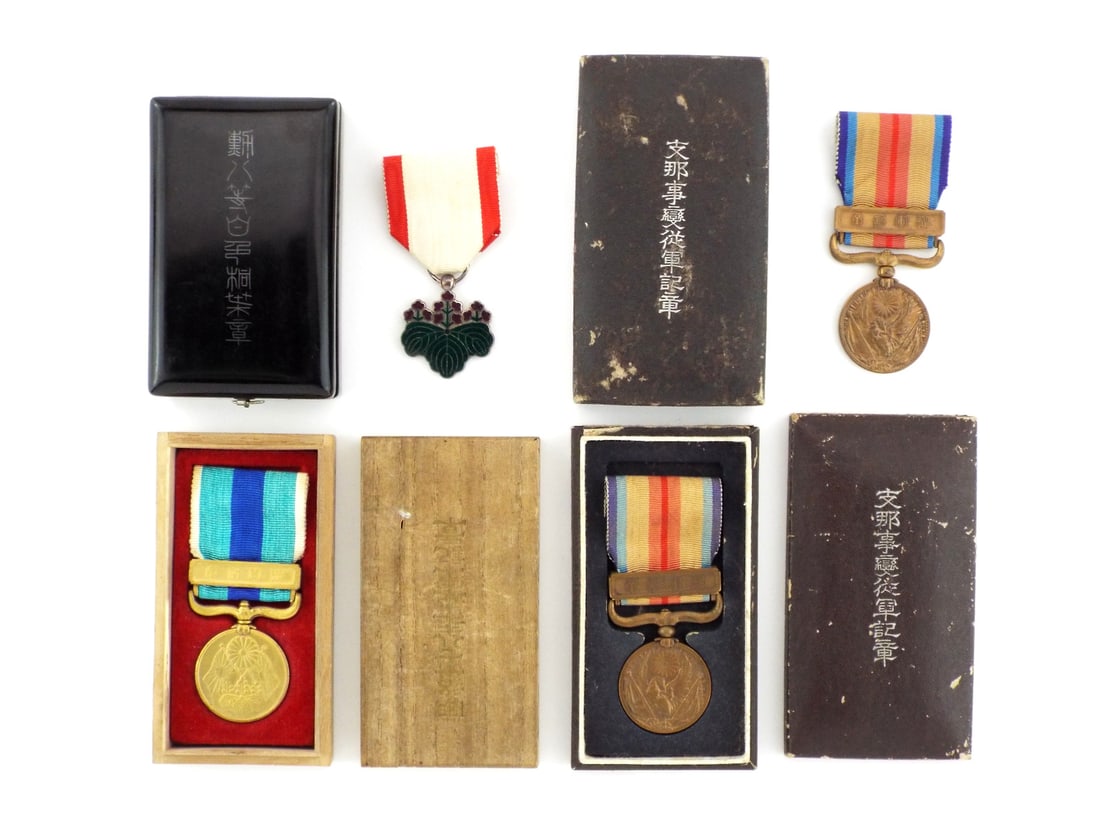 Lot of 4 Japanese Imperial-WWII MEDALS LACQUERED CASES AND GILT FINISH: Group comprises two 1937 China Incident War Medals featuring aged bronze patina and silk ribbons, one Eighth Class Order of the Rising Sun with intact green and purple enamels on silver and a 1940 Nat