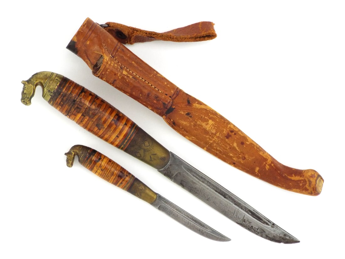 Finnish WWII PUUKKO KNIFE Set Horse Head Pommel: Dual blades showing age related oxidation with engraved inscription detailing the maker and Made in Finland, Kauhava. Stacked birch bark handles displaying lacquer wear and stable compression cracks t