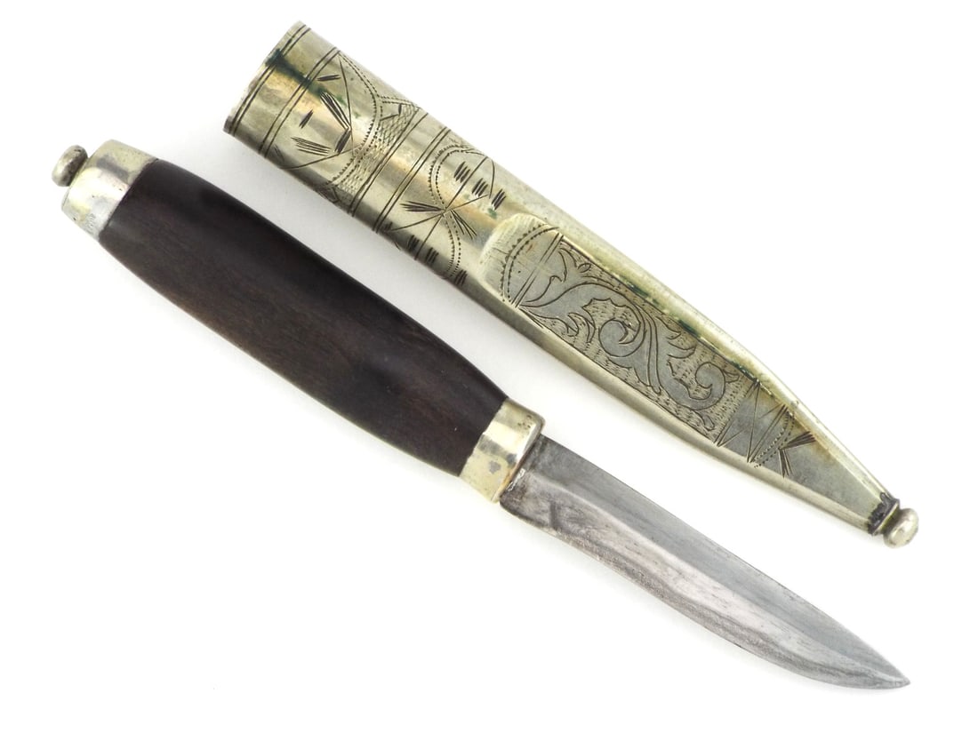 Finnish WWII PUUKKO BELT KNIFE with Silver Engraved Scrollwork: Blade exhibits surface oxidation and sharpening marks. Dark stained birch handle remains solid with a silver bolster. Matching silver sheath features traditional hand engraved scrollwork and geometric