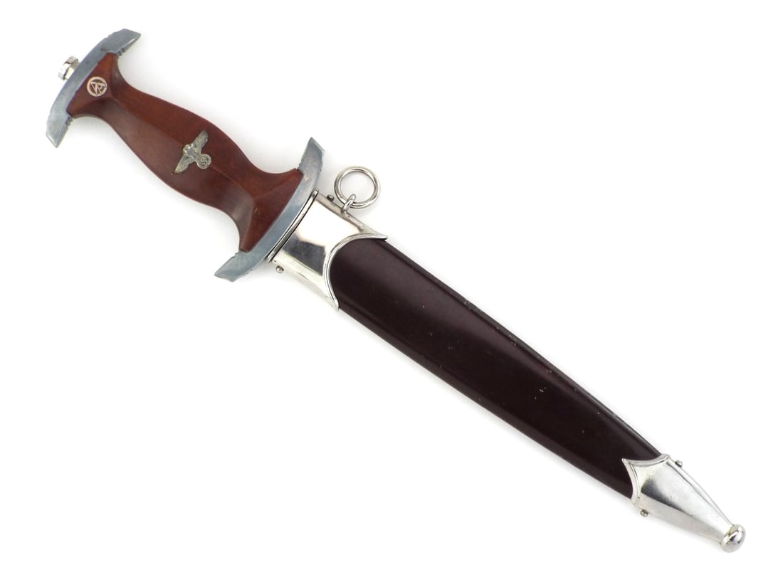 Mint German WWII SA Dagger by E. & F. HORSTER & RZM Number: Double edged blade retains factory polish with visible runner marks and deeply engraved Alles fur Deutschland - Everything for Germany motto, showing RZM M7/36 mark at ricasso. Brown wood grip remains