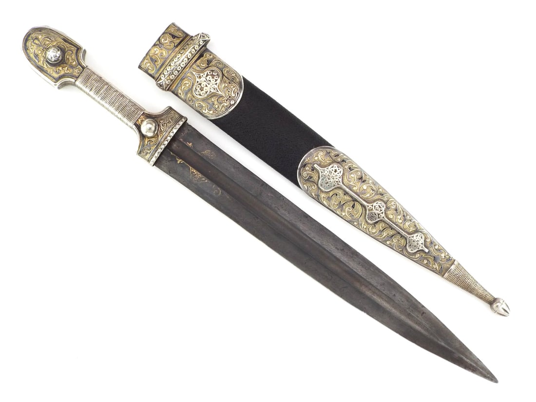 Very Fine Caucasian Late 19th C. Kindjal Dagger SILVER NIELLO WORK & GILDING: Double edged steel blade shows salt and pepper spotting with gold floral work near the bolster, Cyrillic maker stamps deep set in fuller. Silver hilt features wire wrapped grip and nielloed pommel wit