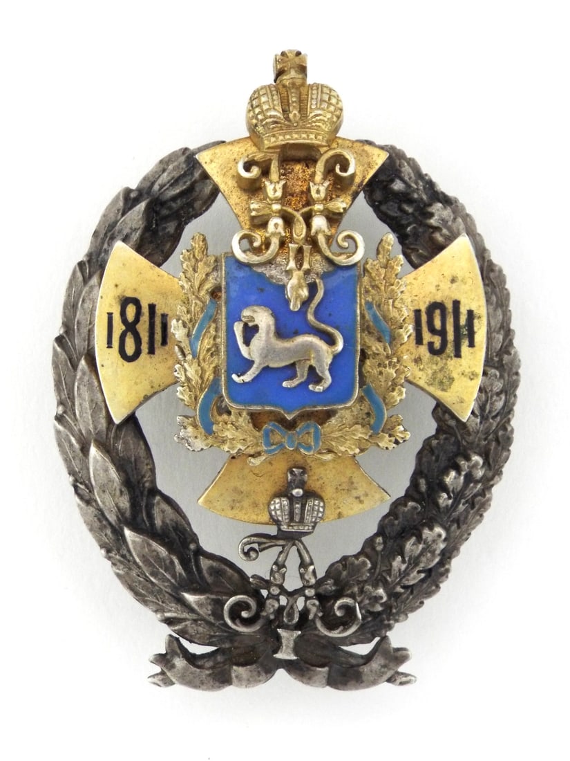 Imperial Russian 100th Anniversary Badge 5TH FINNISH RIFLES REGIMENT In Silver: Silver and gold toned multi piece construction centered by blue enamel shield. Wreath composed of oak and laurel leaves showing light age toning. Applied monograms for Alexander I and Nicholas II flan