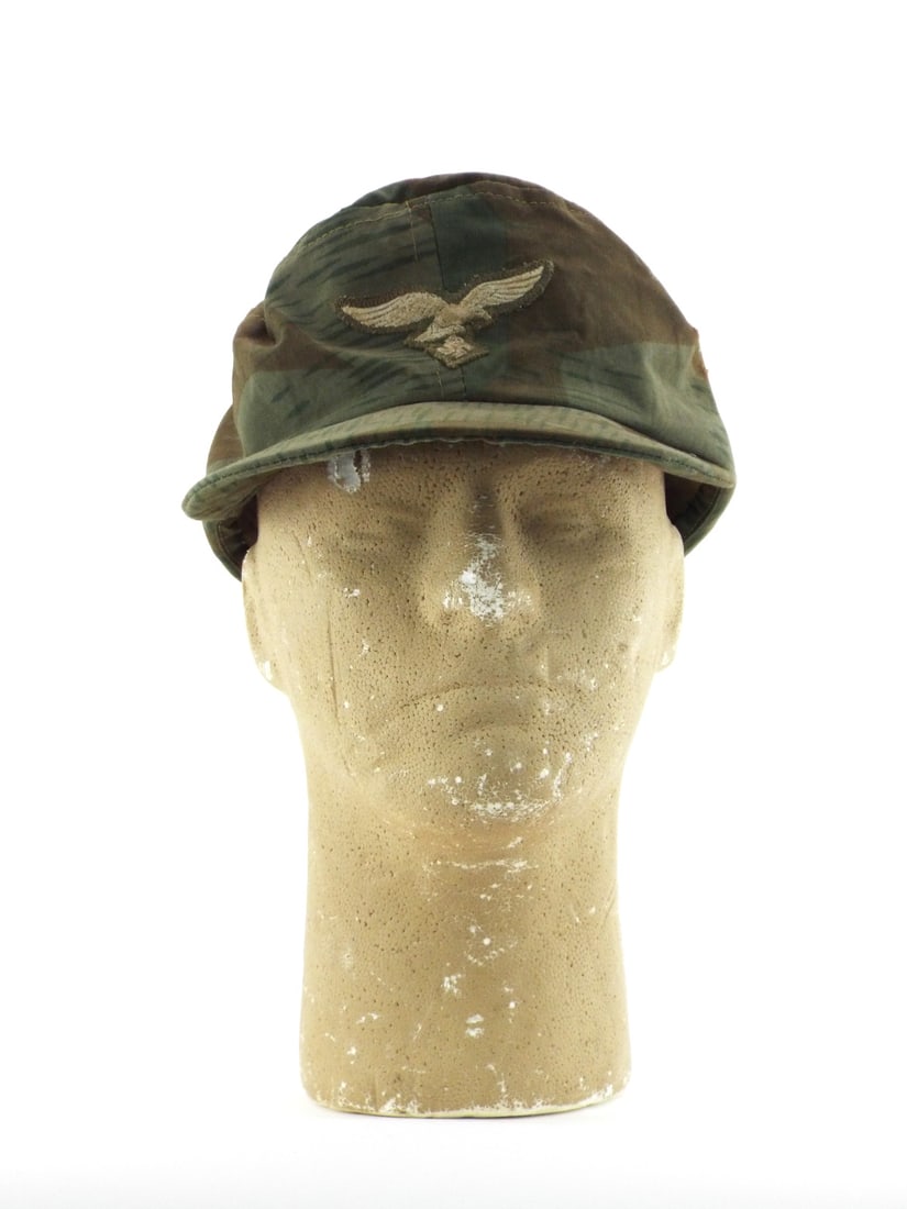 German WWII LUFTWAFFE CAMOUFLAGE FIELD CAP Size 56: Splittermuster 41 camouflage pattern printed cotton body displays field wear with scattered staining and oxidation to metal ventilation grommets. Machine embroidered Luftwaffe eagle remains tightly zi