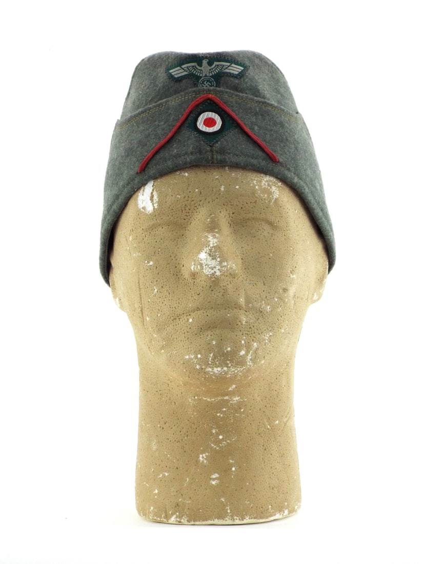 German WWII ARTILLERY SIDE CAP Size 58 Dated 1938: Field grey wool body displays light nap wear and scattered surface tracking with intact ventilation grommets. BeVo woven eagle and national cockade remain factory applied with tight zig-zag stitching.