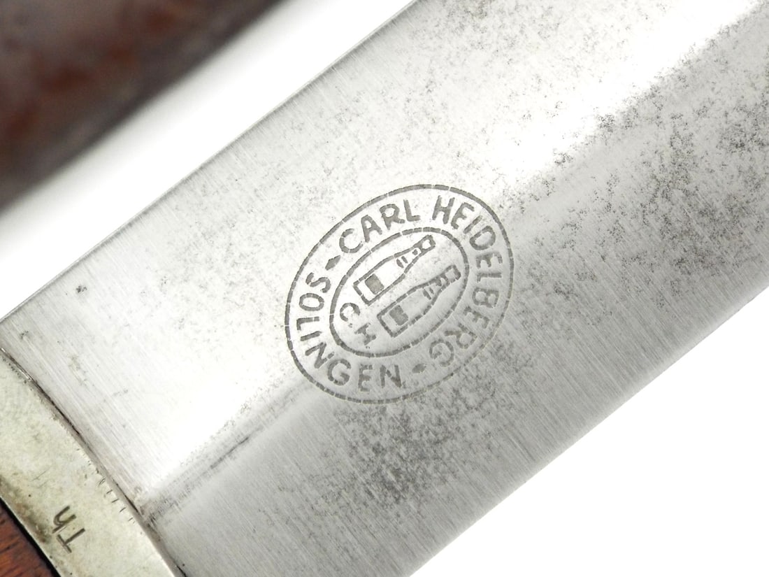 German WWII SA Dagger by CARL HEIDELBERG SOLINGEN: Early production blade shows spotting surface runner marks, featuring acid etched motto Alles fur Deutschland - Everything for Germany. Nickel-silver crossguards display even patina, reverse stamped T
