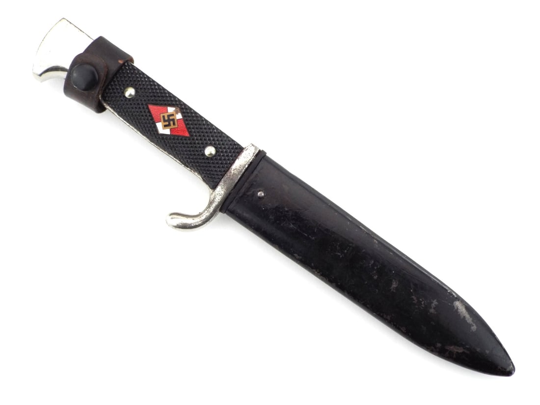 German WWII HJ Knife with RZM and Diamond Enameled Inset: Carbon steel blade displays graying and scattered peppering with visible RZM circle stamp. Nickel hilt shows moderate loss and oxidation to the pommel and crossguard. Checkered black grips remain tigh