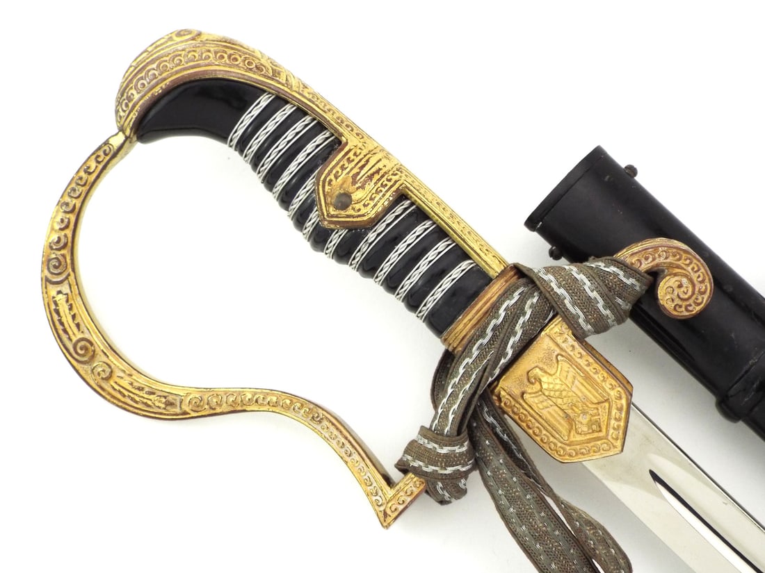 Rare & Fine German WWII WRANGEL FIELD MARSHALL SERIES Officer Sword by EICKHORN: High polish nickel blade featuring the EICKHORN SOLINGEN squirrel logo with light surface scuffs. Gilded brass hilt exhibits patent mark under crossguard with crisp Casberg style eagle langet. Black c