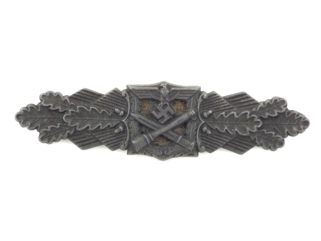 German WWII Close Combat Clasp by JOSEF FEIX & SOHNE Peekhaus Design: Die struck body retains muted bronze wash with heavy lead gray oxidation and honest high point wear. Central square motif features crisp eagle and crossed weaponry over a correctly crimped backing pla