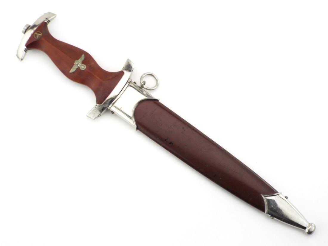 German WWII SA Dagger with C. GUSTAV SPITZER SOLINGEN RZM: Double edged blade shows significant surface oxidation and some runner wear, featuring the etched motto Alles fur Deutschland - Everything for Germany, with reverse RZM M7/80 maker mark. Brown wood gr