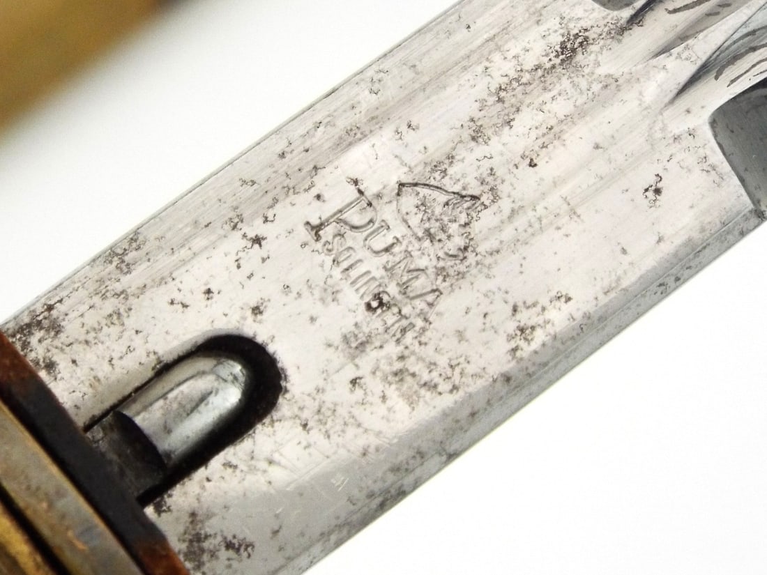 German WWII Navy Officer Dirk by PUMA SOLINGEN & Engraved Blade: Double edged carbon steel blade features fouled anchor floral engravings showing moderate oxidation, ricasso carries stamped Puma Solingen maker mark. Gilded brass crossguard and eagle pommel retain t