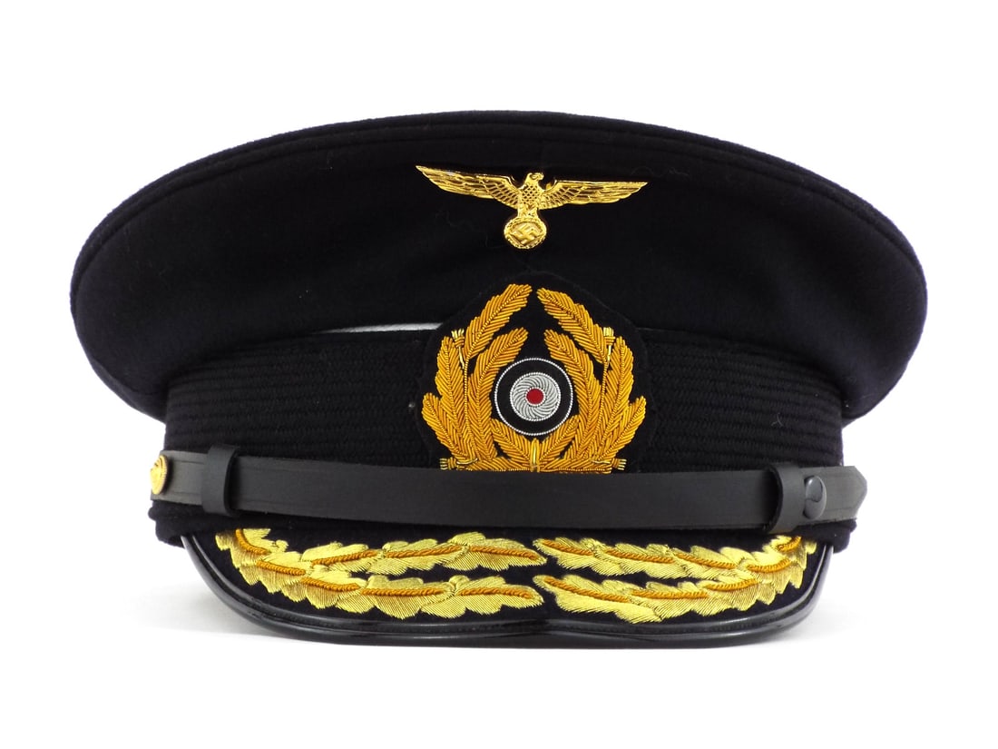 Very Good Quality German Made POST WWII Kriegsmarine Admiral Visor Cap: Dark navy wool body exhibits minimal lint and sharp structural integrity without mothing or crushing. Embroidered gold bullion wreath and double row oak leaf visor decoration show brilliant luster. In