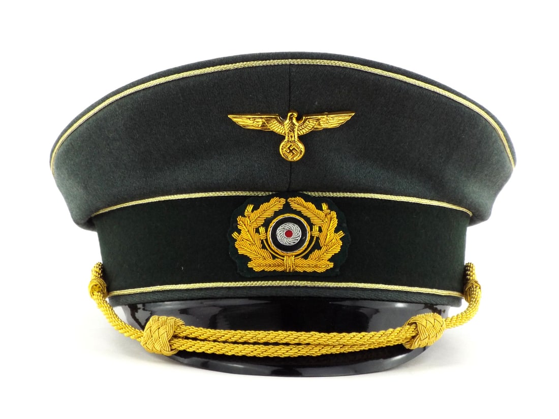Very Good Quality German Made POST WWII Army General Visor Cap: Dark green wool body displays sharp contour with vibrant gold piping and high relief bullion oak leaf wreath. The gilded metal national emblem sits above a crisp tri color cockade. Interior features a