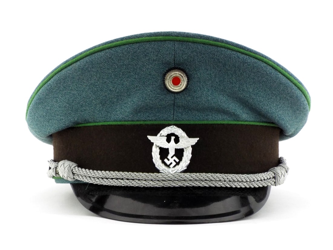 Very Good Quality German Made POST WWII SCHUTZPOLIZEI Police Officer Visor Cap: Police green wool body features bright green piping and dark brown velvet band showing minimal wear. Silver bullion officer cords remain tight over a black vulcanite visor. Interior displays tan silk 
