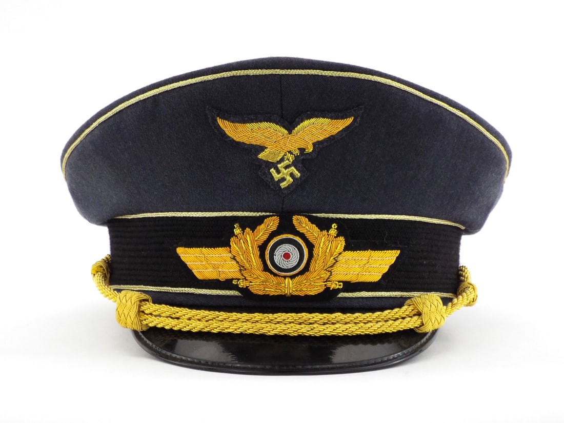 Very Good Quality German Made POST WWII LUFTWAFFE General Visor Cap: Fine blue grey wool tricot body shows minimal wear with prominent gold bullion wire piping. Embroidered gold wire eagle and winged wreath insignia remain bright and tightly secured. Gold bullion chin 