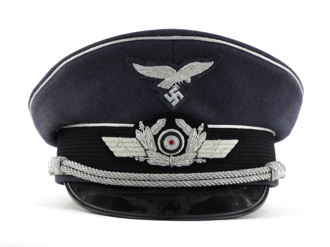 Very Good Quality German Made POST WWII LUFTWAFFE Officer Visor Cap: High grade blue grey wool body presents in excellent state with minimal nap wear. Embroidered silver bullion eagle and wreath insignia remain crisp. Silver piping shows light oxidation. Interior featu