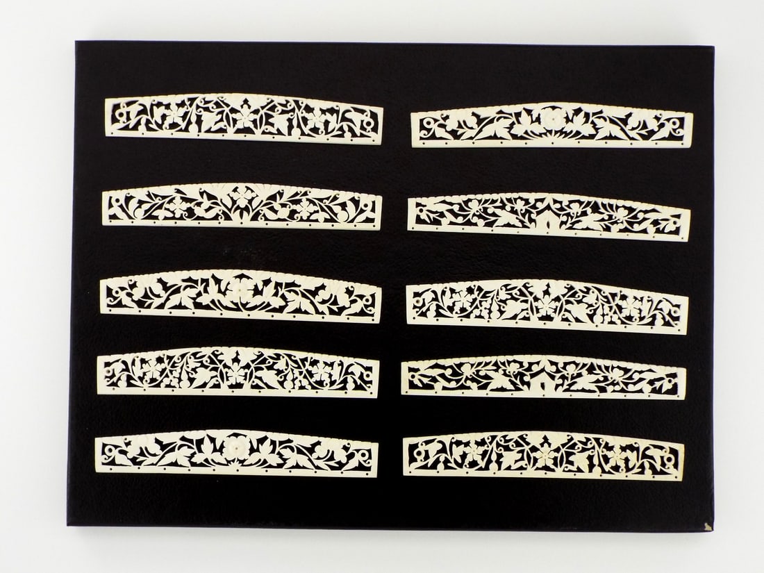Exquisite Antique Chinese VERY FINE CARVED Purse APPLIQUES: This magnificent ensemble of ten pierced FINE BONE purse frame appliques, unveils an exquisite parade of intertwining vines and luxuriant peonies eternally in bloom. Each gently arched openwork strip,