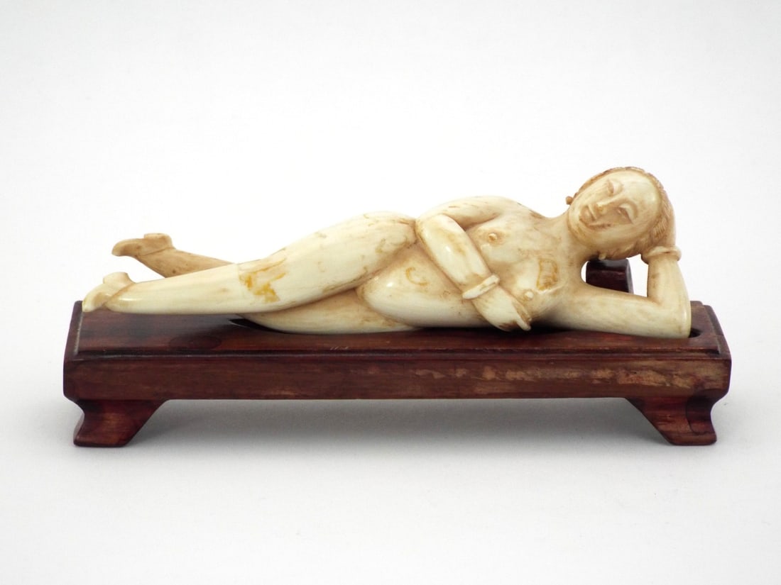 Chinese 19th C. Very Fine Hand Carved DOCTOR LADY: Reclining female form exhibits characteristic Schreger lines with scattered ochre staining. Deeply carved facial features and feet show mild surface smoothing. Solid rosewood couchbase displays minor 