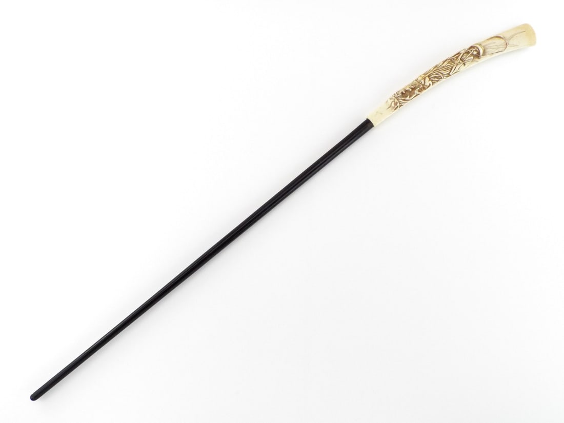 Very Fine Japanese 19th C. CARVED BONE CANE Mythological Dragon & Sage: Polished ebony shaft displays minor surface abrasions. The terminal features an intricately and Very Fine carved handle depicting a traditional fisherman and dragon motif. Fine age related hairline dr