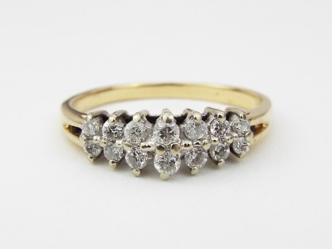 14K Gold Double Row Diamond Ring: Double tier cluster head set with round cut diamonds totaling 0.70 carats, prongs show light surface wear. The 14k yellow gold band displays a classic split shoulder design with a visible 14K hallmark