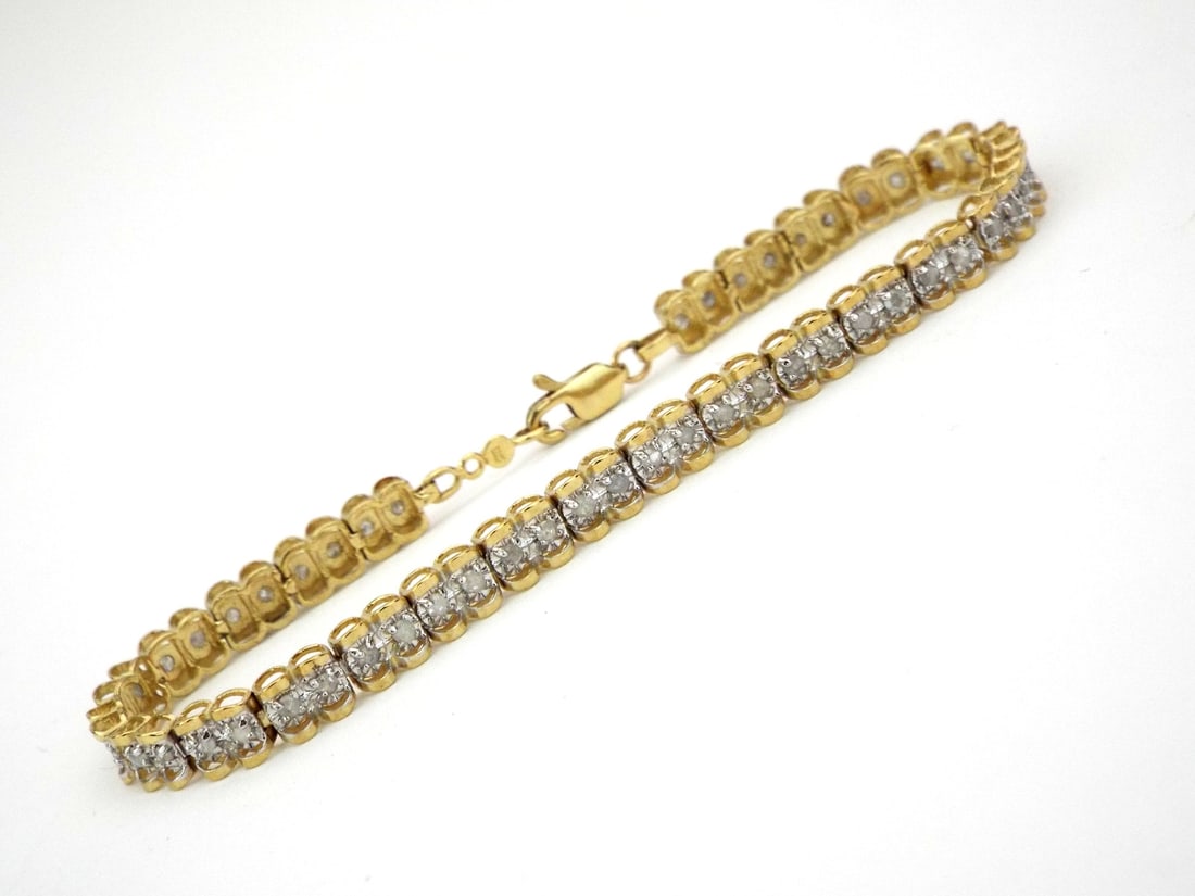 10K YELLOW GOLD DIAMOND BRACELET: Articulated yellow gold S-link body exhibits light surface wear and consistent polish. Each miracle set station contains round cut diamonds totaling 0.5 carats, showing typical inclusions and milky cl