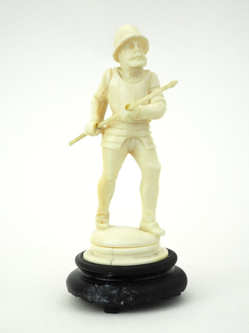 Very Fine Indian CARVED HUNTER FIGURINE: Finely detailed colonial hunter body displays natural age toning. Subject grips a pike while a quillon dagger remains fixed to the rear belt. Mounted on a solid turned wood pedestal base showing chara