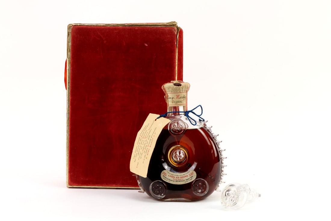 Rare French WWII Era REMY MARTIN BACCARAT CRYSTAL Louis XIII Casket: Grande Champagne cognac in hand blown crystal decanter with three fleur-de-lis medallions and intact side fins. Deep amber contents show exceptional fill level into neck. Original lead foil and red US