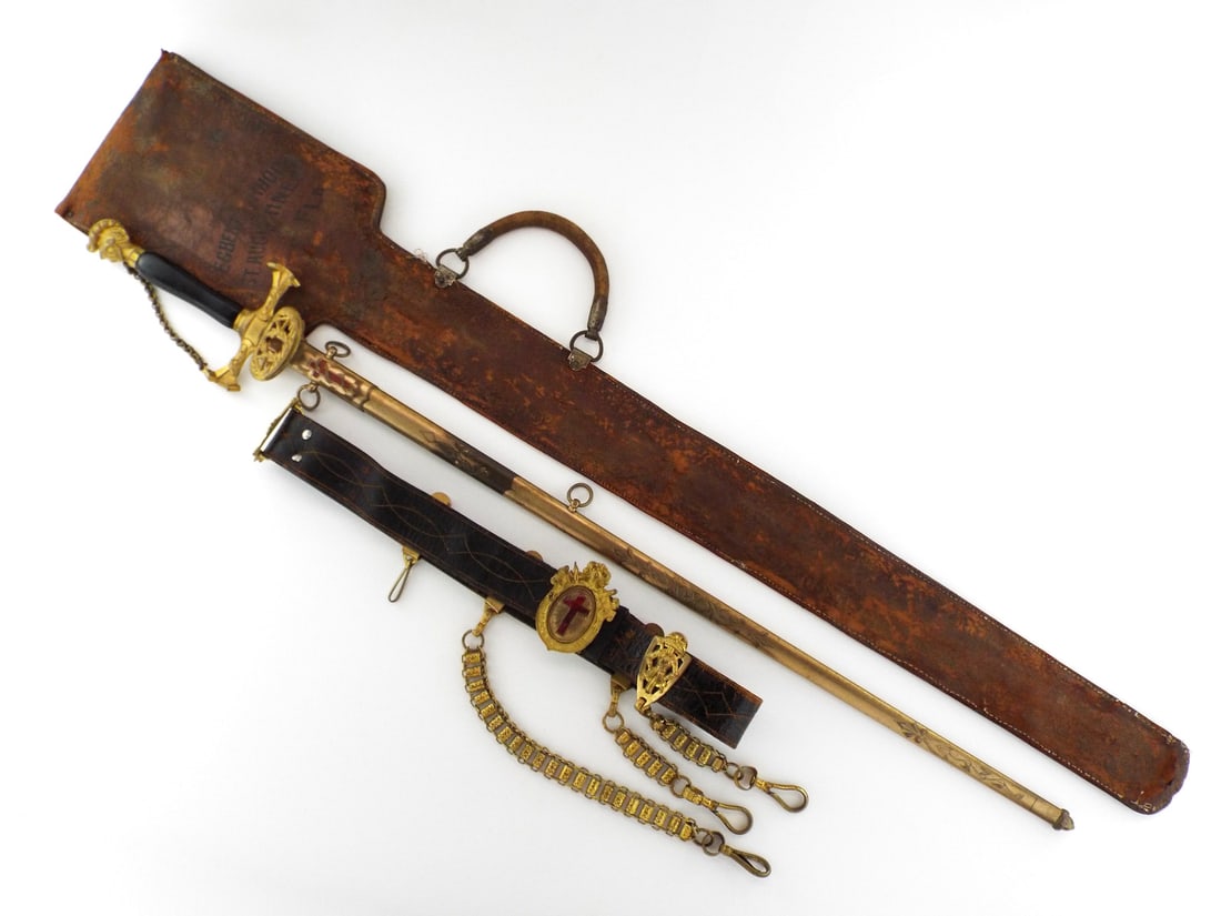 US Fraternal Knights Templar Sword with BELT HANGERS & Carrying Case: Etched straight steel blade displays standard floral motifs, inscribed to Alvin Clark and Trinity Commandery, showing minor runner wear and scattered oxidation. Black ebonized wooden grip remains soli