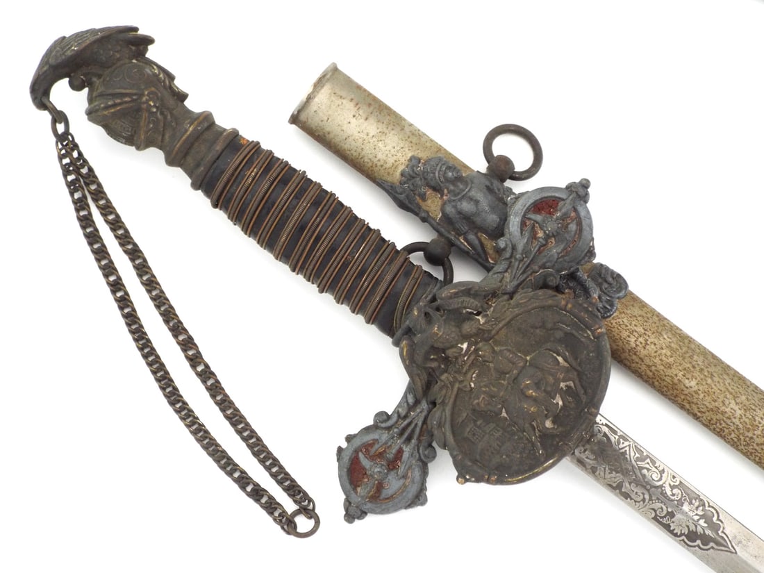 US 19th C. KNIGHTS OF PYTHIAS FRATERNAL SWORD: Engraved blade displays Knights of Pythias title and F.C.B. motto with surface oxidation. Cast metal hilt features knight head pommel with bird finial and wire wrapped leather grip showing minor loss.