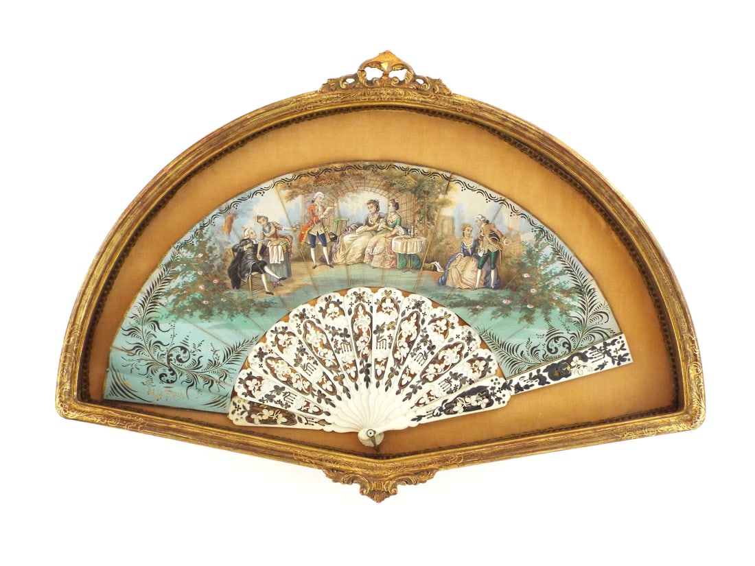 French Victorian Painted Folding Fan with CARVED BONE STICKS & Pique Work: Lithographed paper leaf features a Rococo courtship scene showing light vertical splitting along folds and moderate age toning to the green borders. The intricately pierced bone sticks display excelle