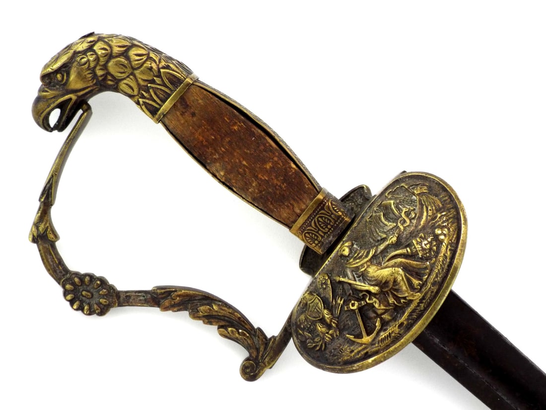 Rare Early American 1820s NAVAL OFFICER Sword or REVENUE CUTTER SERVICE with Eagle Head Pommel: Straight dress blade displays a dark oxidized gray patina with faint remnants of floral etching near the ricasso. Cast brass hilt features a detailed eagle head pommel, wood slab grip scales and a rel