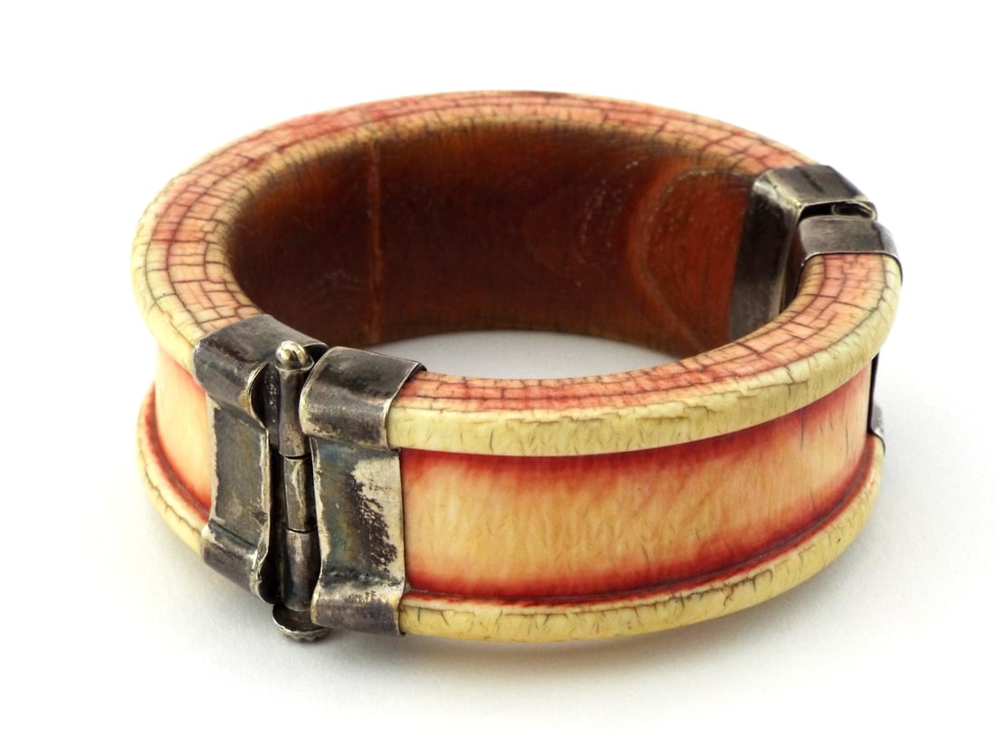 Very Fine Tibetan 19th C. Hinged Bangle with SAFFRON DYE: Heavily patinated body displays a characteristic craquelure surface with deep saffron stained pigment to the recessed channels. Two part construction secured by a silver alloy pin and socket hinge mec