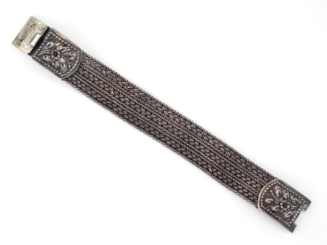 Italian Sterling Wide Braided Bracelet.925 SILVER: Triple register weave of dense sterling silver, demonstrating high tension manual braiding with a grey patina across the interwoven links. The body transitions into a magnificent box clasp featuring i
