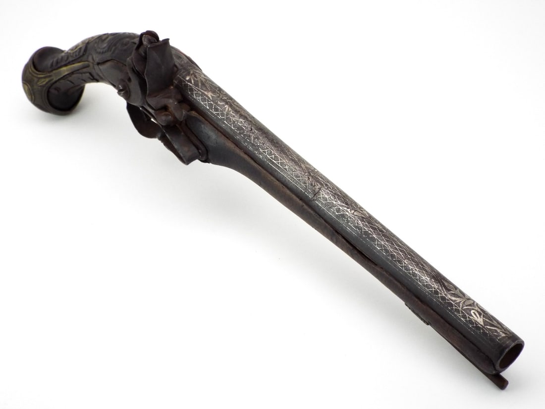 Ottoman Balkan 18th-19th C. Flintlock Holster Pistol ENGRAVED OVERLAYS: Two stage barrel transitions from octagonal breech to round, featuring overlays with Islamic motif chasing. Flintlock mechanism exhibits internal mainspring and swan neck cock. Walnut stock tapering t