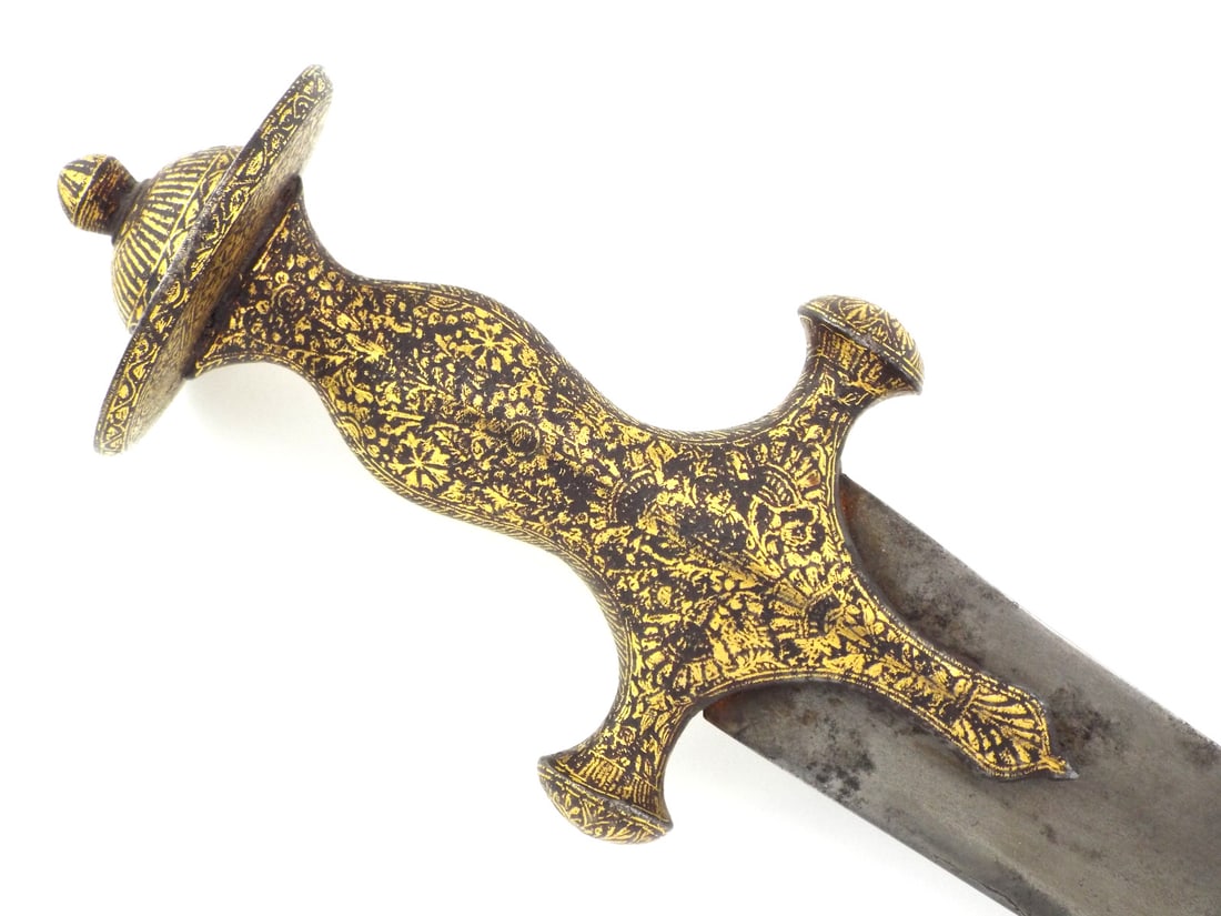 Indian Mughal Islamic Shamshir with WOOTZ BLADE & Gold Decorated Handle: Gently curved wootz blade displaying a fine, tight crystalline grain throughout with a single shallow fuller and a gold floral cartouche at the forte. The surface shows minor oxidation spots and a dar