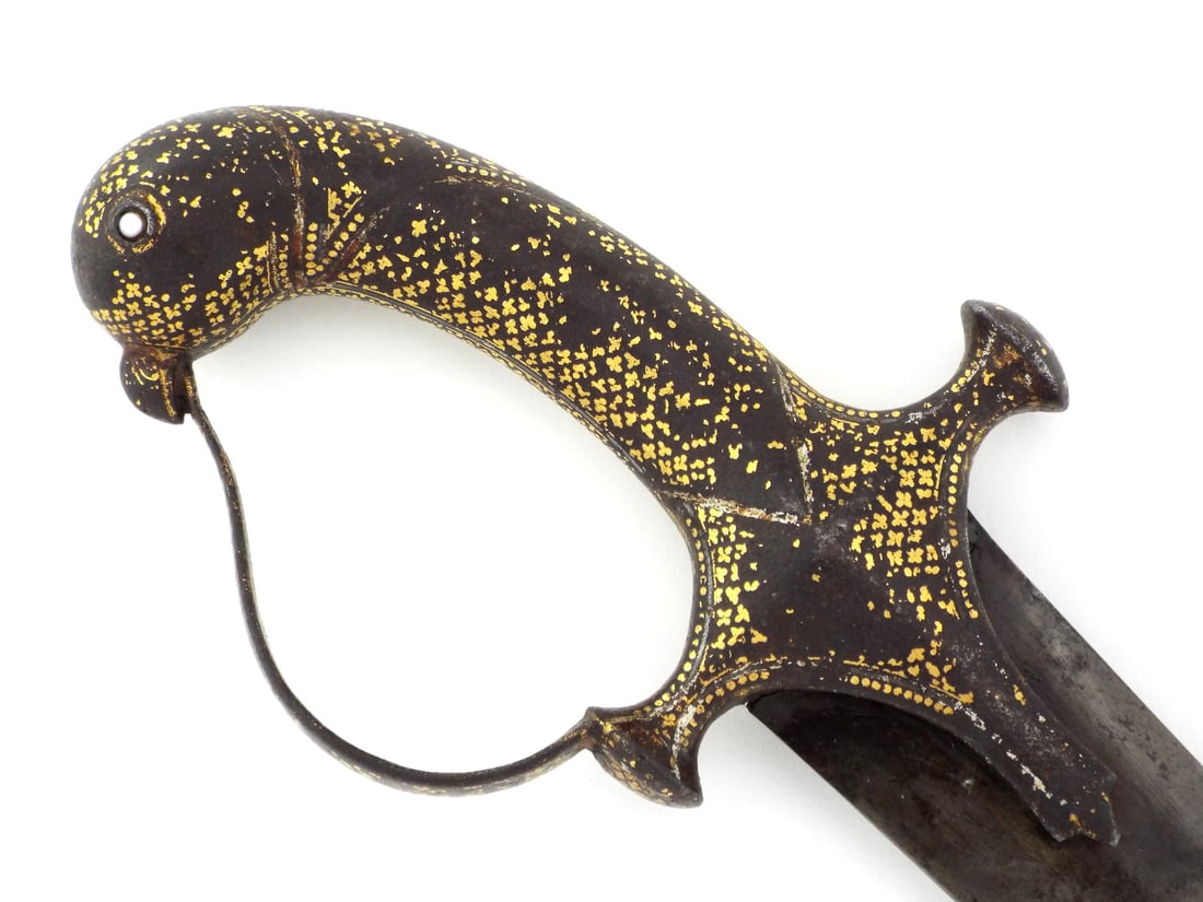 Indian Mughal WOOTZ BLADE Shamshir Sword with Gold Decorated Hilt: Curved blade displays a fine, tight wootz pattern with mild surface oxidation and a dark grey patina. The iron hilt features a bird head pommel with inset pearl eyes and extensive gold floral overlay 
