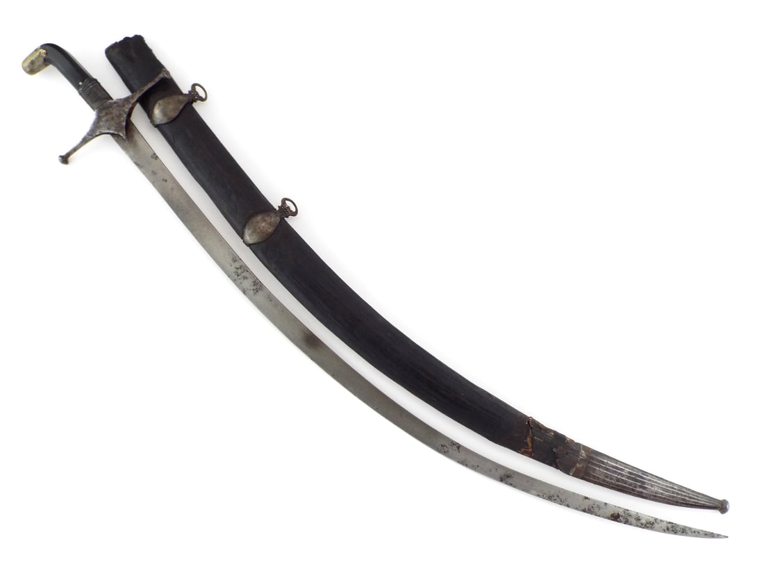 Indo-Persian Shamshir with WOOTZ PATTERN Blade & Horn Grip: Deeply curved blade exhibiting a distinct high contrast wootz crystalline structure with localized oxidation. The steel crossguard and langets show a dark, undisturbed patina with faint traces of etch