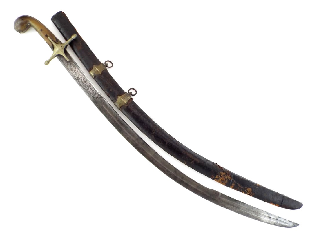 Ottoman Shamshir Carved HILT & ISLAMIC CALLIGRAPHY: Single edged curved blade displays heavy engraving featuring calligraphic Islamic invocations with moderate oxidation. Hilt composed of horn scales secured by iron pins showing age shrinkage and minor