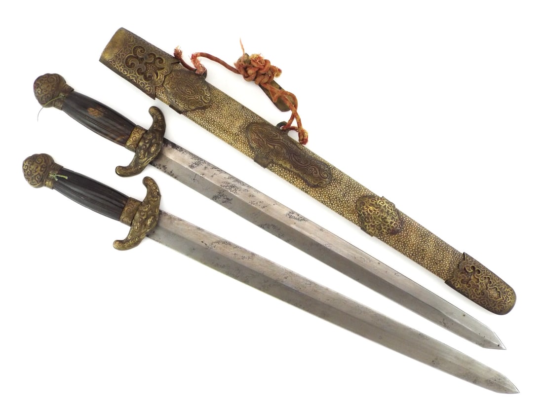 Scarce Chinese 18th-19th C. TWIN SHORT SWORDS Fine Shagreen Scabbard: Matching pair of blades exhibiting moderate oxidation. Shared guard features a cast brass ogre mask over fine dual contoured horn grips with vertical fluting. Brass pommel shows honest wear. Beautiful